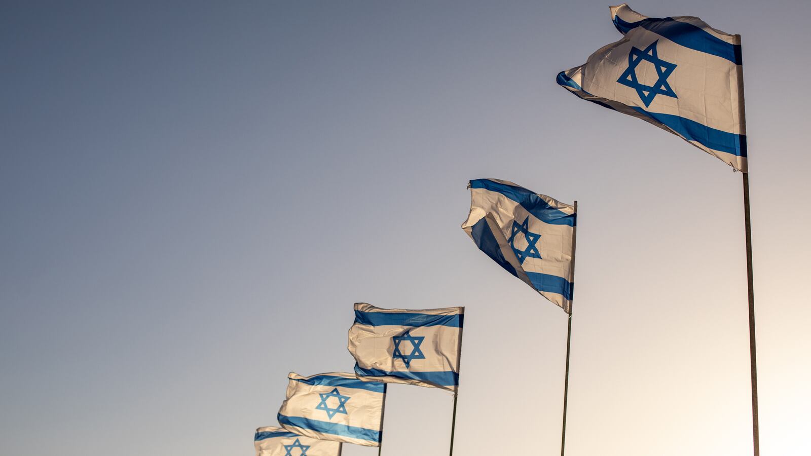 Several flags of Israel flying outside the historic Old City of Jerusalem in Israel.