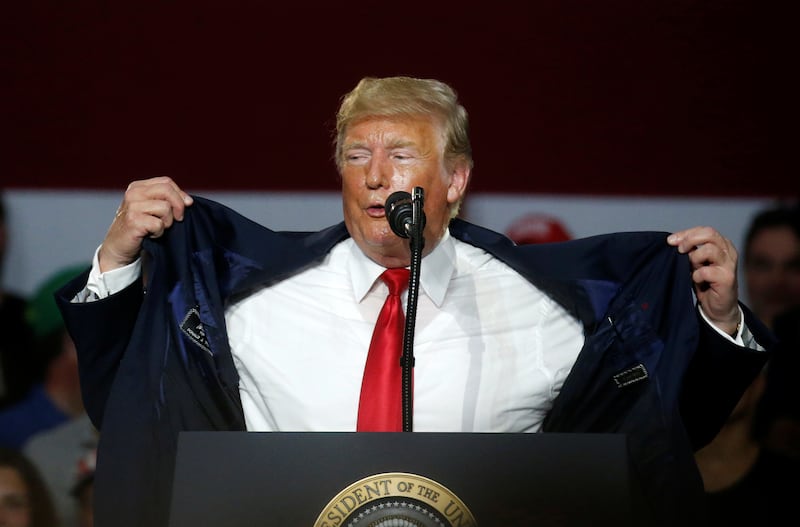 U.S. President Donald Trump makes a comment about how hot the room is during his Make America Great Again rally in Olentangy Orange High School in Lewis Center, OH, U.S., August 4, 2018. REUTERS/Leah Millis