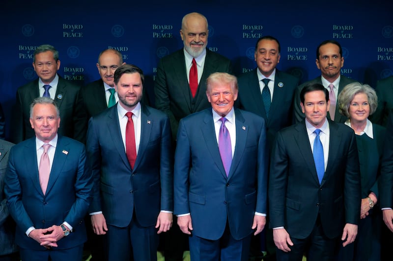 President Donald Trump is joined for a family photo along with U.S. Vice President JD Vance, U.S. Secretary of State Marco Rubio, White House Chief of Staff Susie Wiles and other Board of Peace representatives.