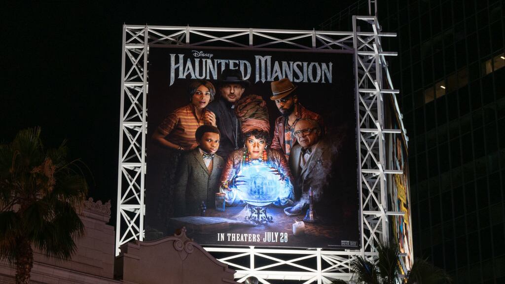 A billboard promoting the Disney movie “Haunted Mansion.”