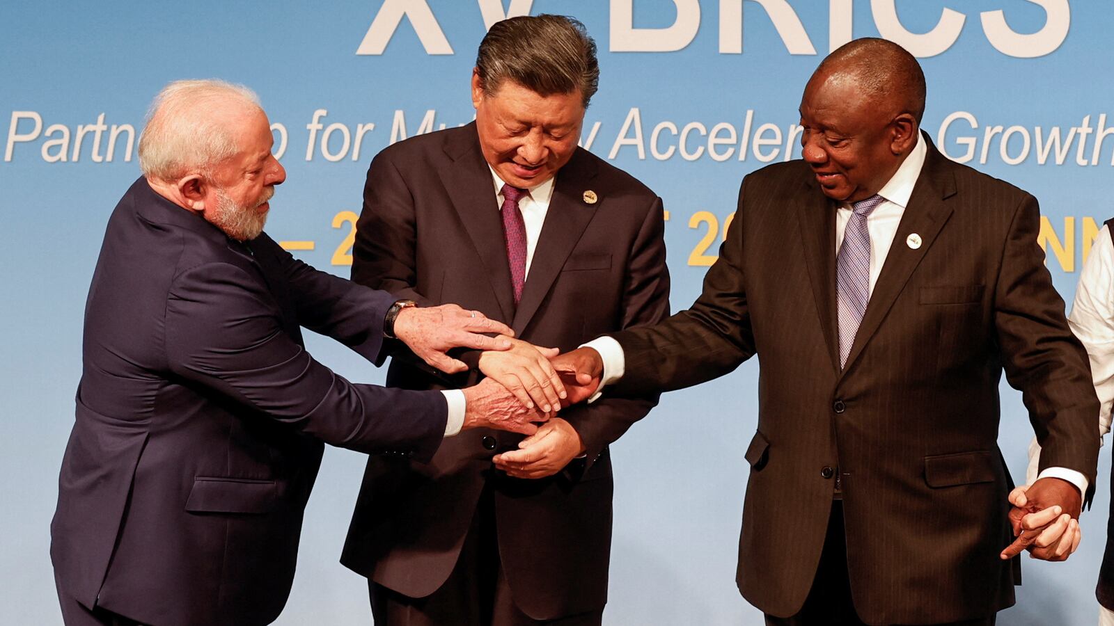 President of Brazil Luiz Inacio Lula da Silva, President of China Xi Jinping, and South African President Cyril Ramaphosa gesture during the 2023 BRICS Summit in Johannesburg, South Africa, Aug. 23, 2023.