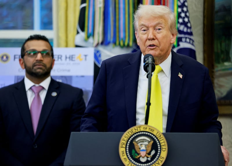 FBI Director Kash Patel listens while U.S. President Donald Trump speaks during a press conference in the Oval Office at the White House in Washington, D.C., U.S., October 15, 2025.