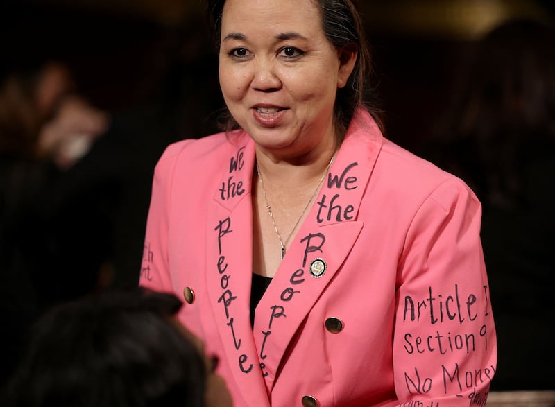 Rep. Jill Tokuda (D-HI) wears a jacket with writing of the U.S. Constitution on the floor of the U.S. House of Representatives