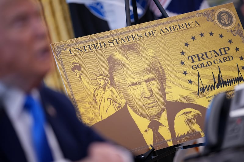 WASHINGTON, DC - SEPTEMBER 19: A poster of the “Trump Gold Card” is seen as President Donald Trump delivers remarks in the Oval Office at the White House on September 19, 2025 in Washington, DC. The “Trump Gold Card” is a visa that allows foreign nationals permanent residency and a pathway to U.S. citizenship for a $1 million investment in the United States. (Photo by Andrew Harnik/Getty Images)