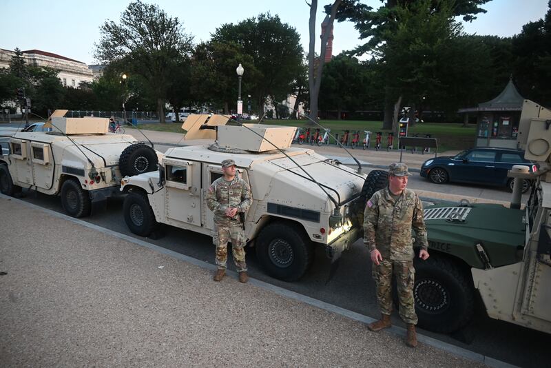 WASHINGTON, DC, UNITED STATES - AUGUST 12: Members of the DC National Guard assemble with military vehicles in front of the Washington Monument as part of President Trump's crime reduction efforts in the District of Columbia in Washington, DC, United States on August 12, 2025.