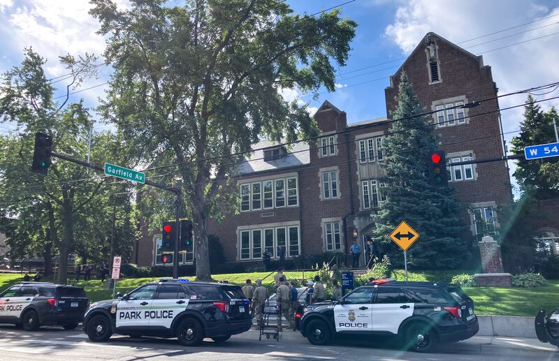 Police and first responders work at the scene of a shooting at the Annunciation Church and Catholic School in Minneapolis.