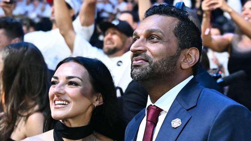 FBI Director Kash Patel smiles with singer girlfriend Alexis Wilkins at the end of the UFC Freedom 250 mixed martial arts event on the South Lawn of the White House.