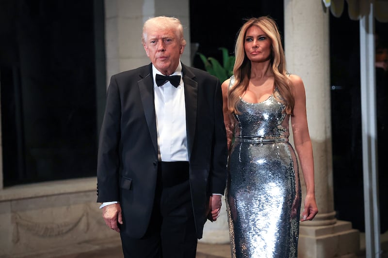 President Donald Trump and first lady Melania Trump arrive for a New Year’s Eve event at his Mar-a-Lago home on December 31, 2025 in Palm Beach, Florida.