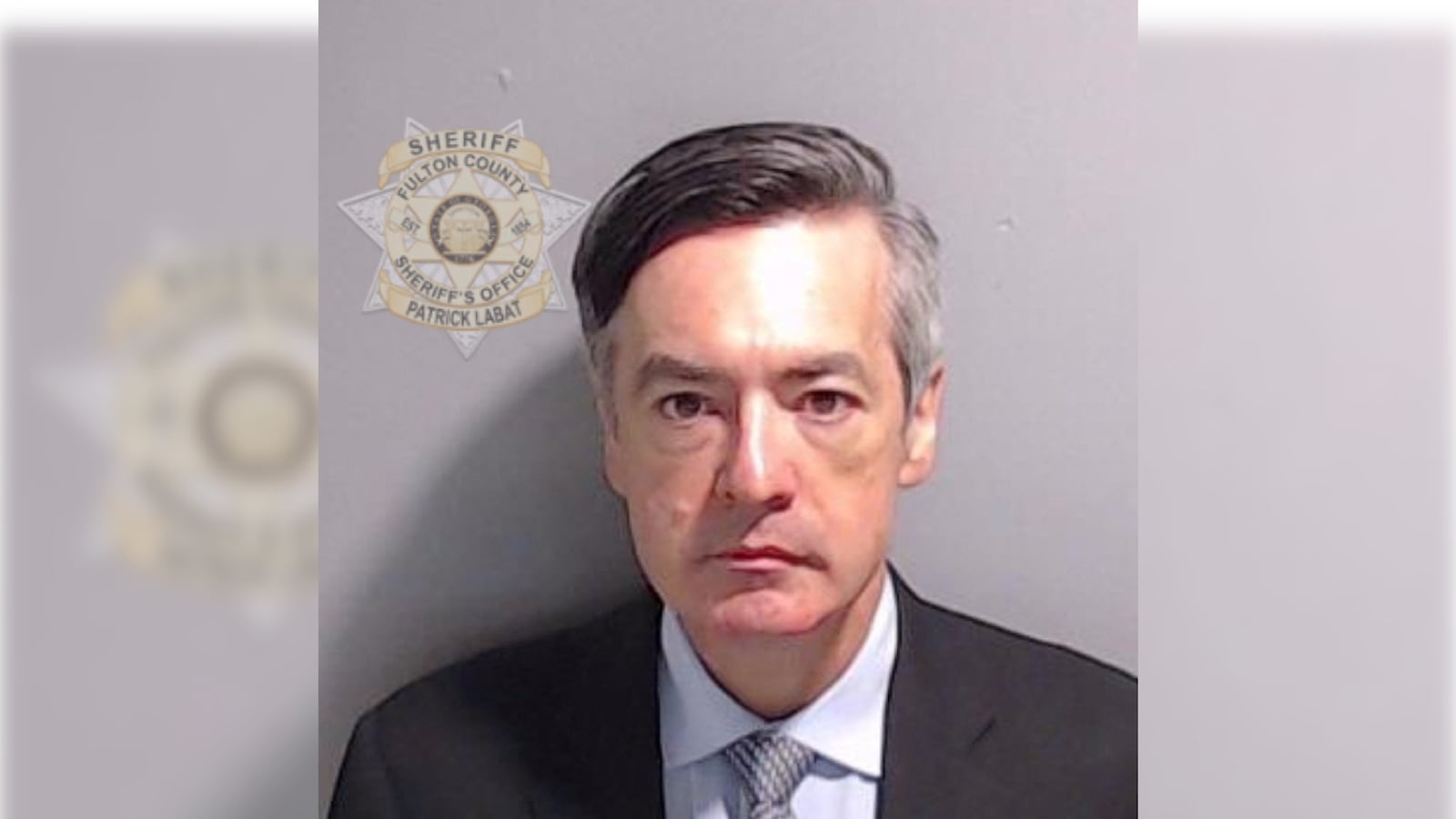 Kenneth Chesebro is shown in a police booking mugshot