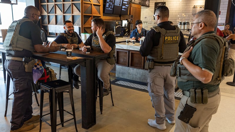 United States Immigration and Customs Enforcement (ICE) agents gather at a coffee shop, after hundreds of Immigration and Customs Enforcement agents were ordered to deploy to airports to help fill TSA staffing gaps, at Luis Munoz Marin International Airport in Carolina, Puerto Rico, March 24, 2026. REUTERS/Ricardo Arduengo