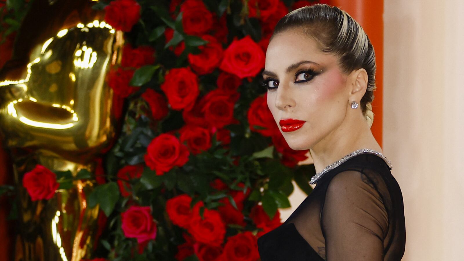 Lady Gaga poses on the champagne-colored red carpet during the Oscars arrivals at the 95th Academy Awards in Hollywood, Los Angeles, California, March 12, 2023.