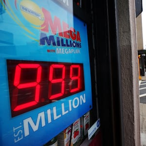 A Mega Millions sign is illuminated inside a store.
