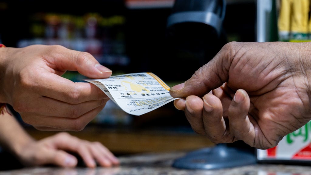 A customer purchases a Powerball lottery ticket at the Brew Market & Cafe on October 10, 2023 in Austin, Texas.