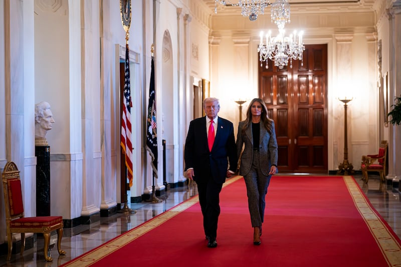 President Donald Trump and First Lady Melania Trump arrive to sign an executive order on foster children and families in the East Room of the White House on November 13, 2025 in Washington, DC.