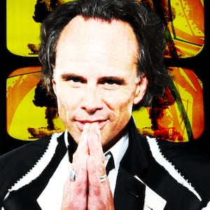 Walton Goggins in front of images of nuclear explosions