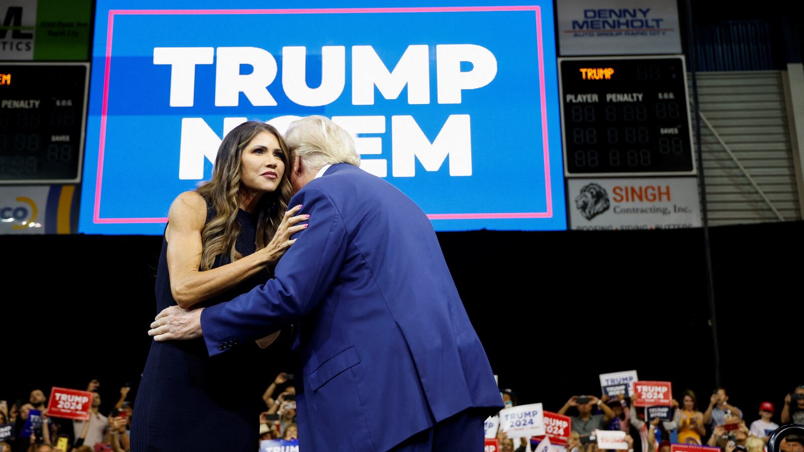 Donald Trump hugs Kristi Noem as he takes the stage in 2023.
