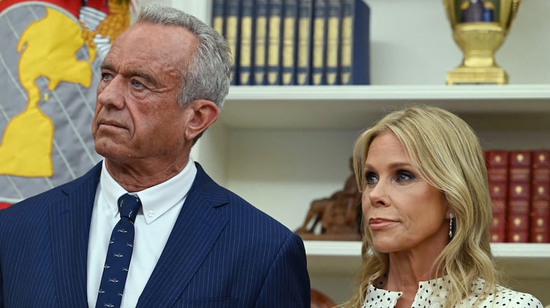 Robert F. Kennedy Jr. (L) and his wife Cheryl Hines listen to US President Donald Trump before a swearing in ceremony for Kennedy as Secretary of Health and Human Services in the Oval Office of the White House in Washington, DC, on February 13, 2025