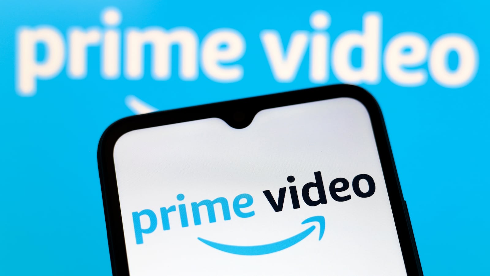 The Amazon Prime Video logo appears on the screen of a smartphone and in the background on the computer screen in Reno, United States, on December 15, 2024.