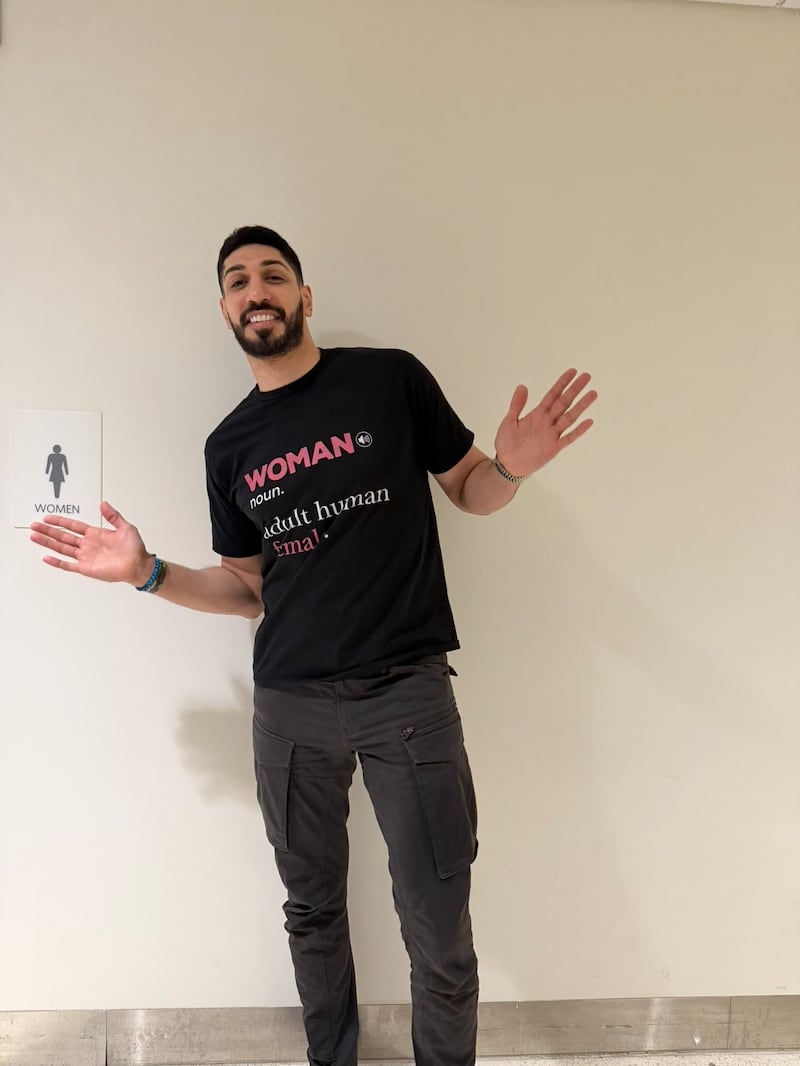 Enes Kanter Freedom outside a woman's bathroom.