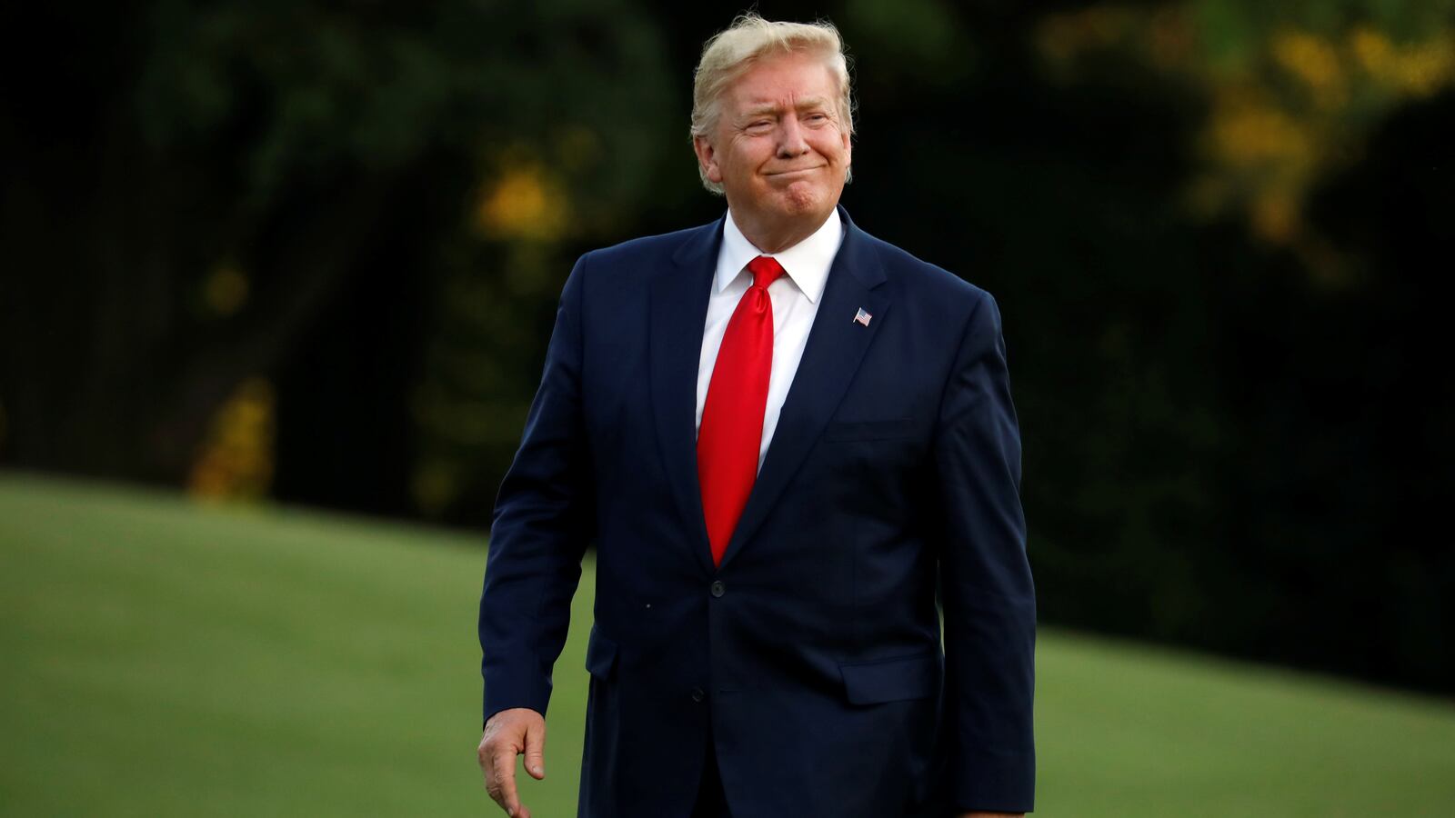 Donald Trump smiles as he as walks on the South Lawn of the White House, June 30, 2019.