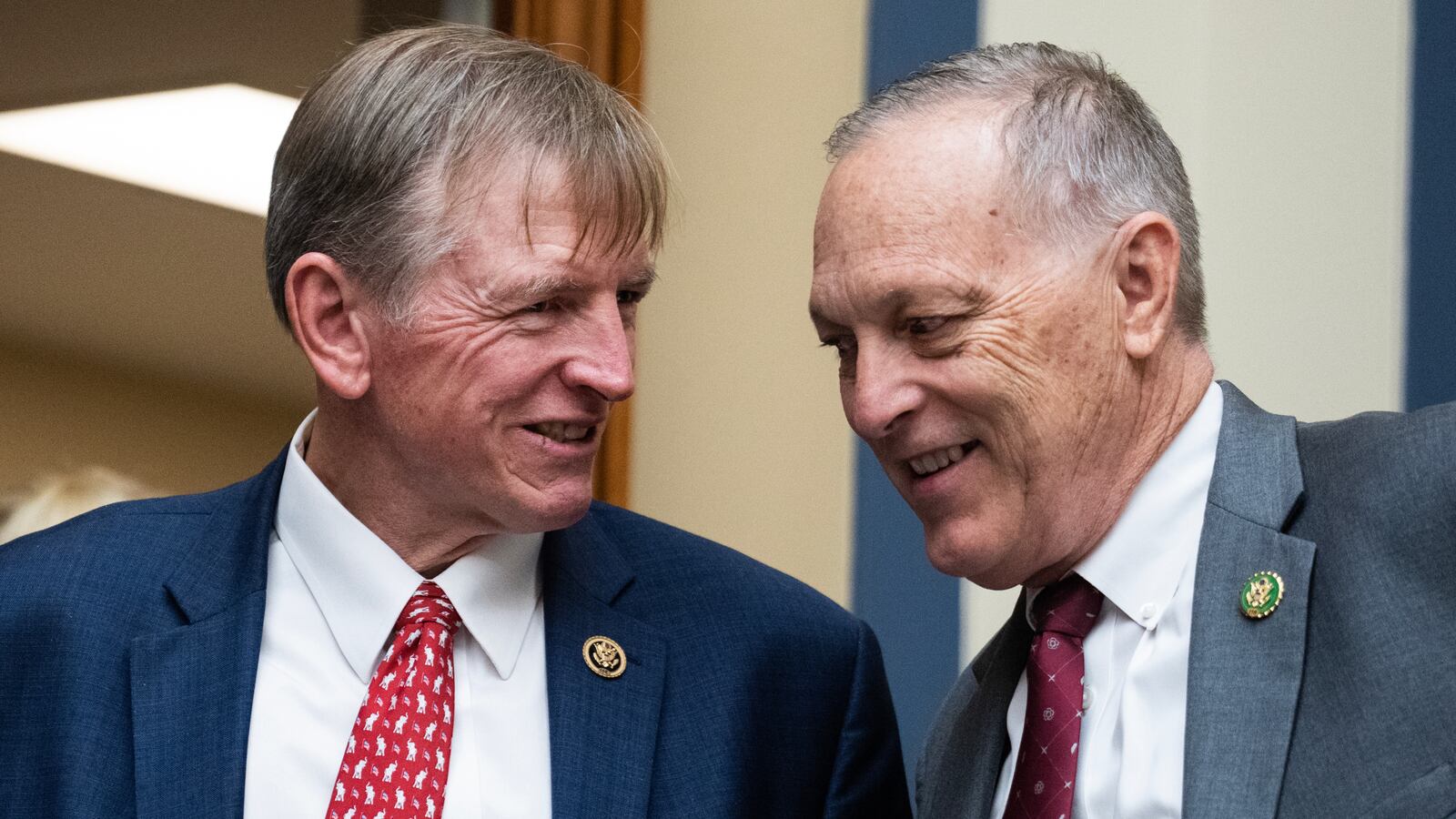 A photo of Reps. Paul Gosar and Andy Biggs, chatting and grinning.