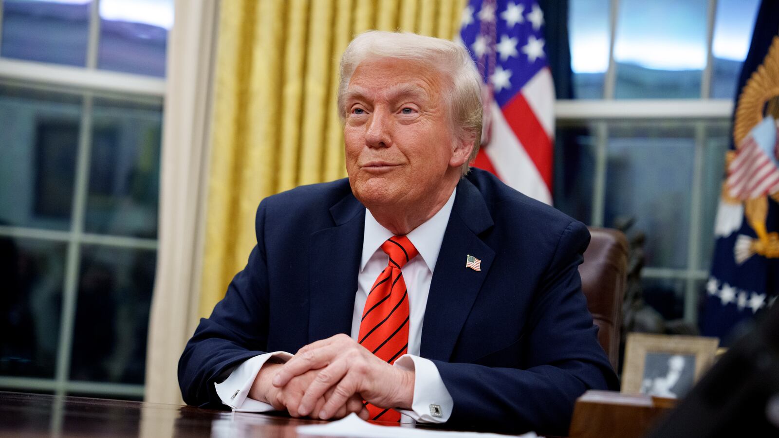 President Donald Trump signs executive orders in the Oval Office on Feb. 10.