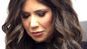 U.S. Secretary of Homeland Security Kristi Noem bows her head.