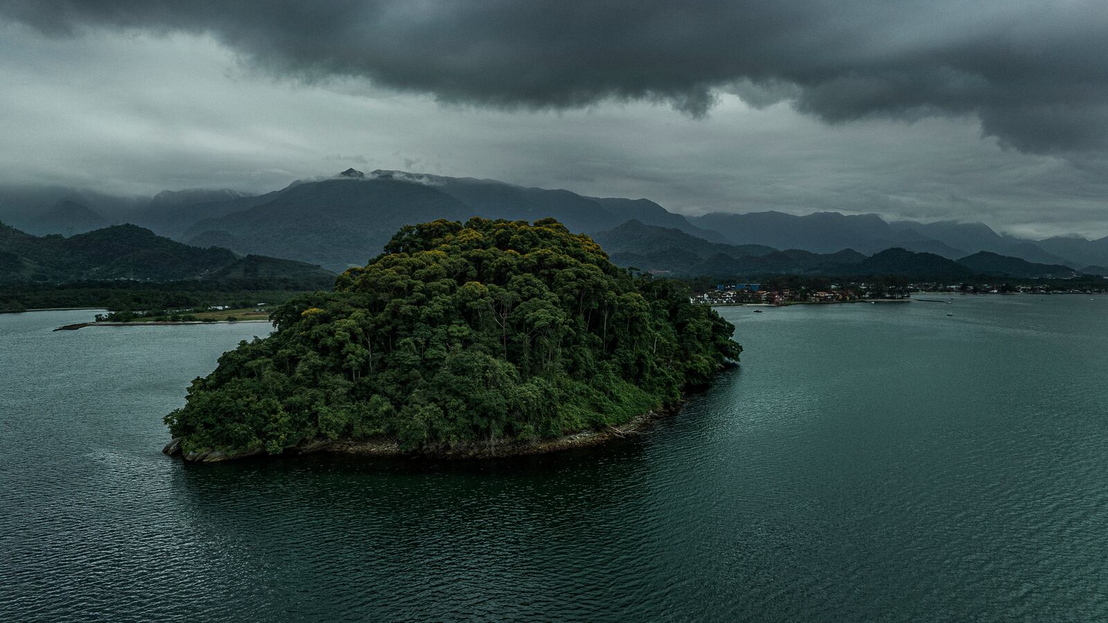 A boat carrying the Afrorigens expedition team sails past the mouth of the Bracuí River, where the shipwreck was discovered, near the island of Cunhambebe Mirim.