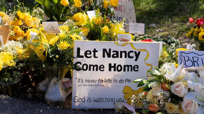 A sign pleads for the return of Nancy Guthrie shortly after her disappearance almost six months ago.