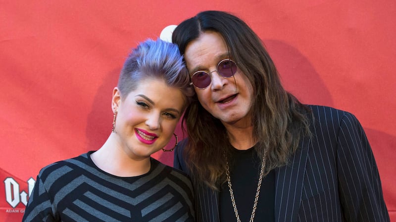Musician Ozzy Osbourne (R) and his daughter Kelly Osbourne pose at the 2014 MusiCares MAP Fund Benefit concert at Club Nokia in Los Angeles, California.
