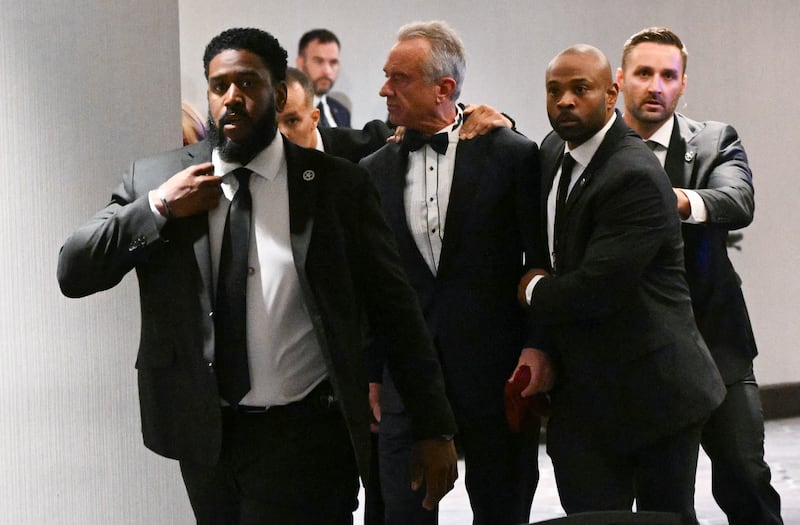 US Secretary of Health and Human Services Robert F. Kennedy Jr. is rushed out by Secret Service agents after loud bangs were heard during the White House Correspondents' dinner at the Washington Hilton in Washington, DC, on April 25, 2026.