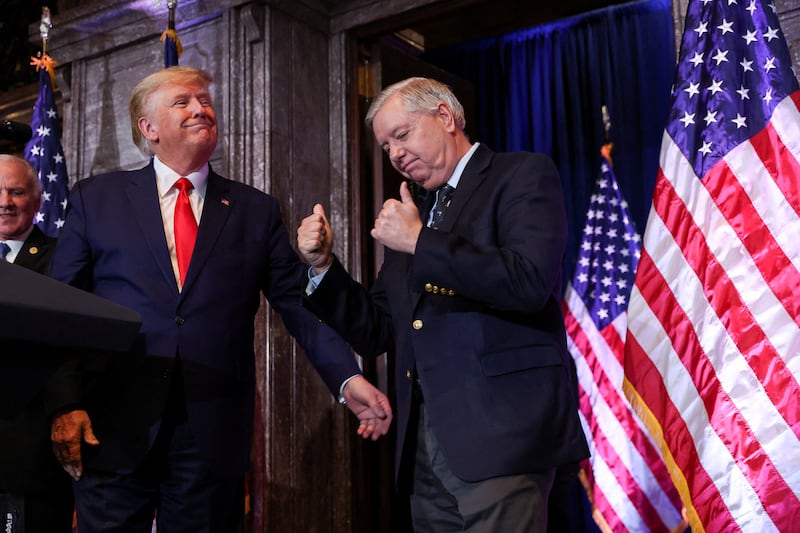 FILE PHOTO: U.S. Senator Lindsey Graham (R-SC) gestures, while standing next to former U.S. President Donald Trump, during Donald Trump's campaign stop to unveil his leadership team, at the South Carolina State House in Columbia, South Carolina, U.S., January 28, 2023. REUTERS/Shannon Stapleton/File Photo