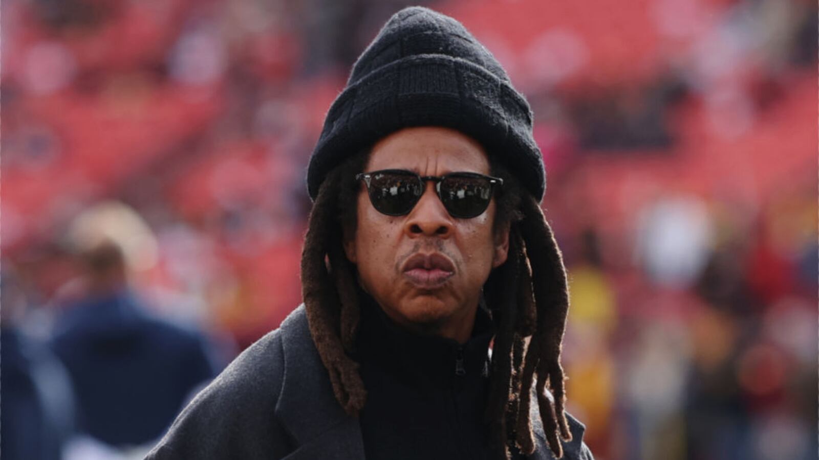 Rapper Jay-Z (C) looks on before a game between the Washington Commanders and the Dallas Cowboys at Northwest Stadium on November 24, 2024 in Landover, Maryland.