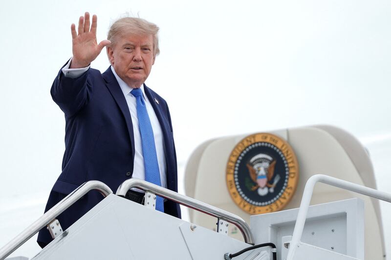 U.S. President Donald Trump gestures, as he boards Air Force One en route to John F. Kennedy International Airport, at Joint Base Andrews, Maryland, U.S., August 14, 2026. REUTERS/Ken Cedeno
