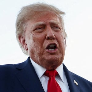U.S. President Donald Trump speaks to members of the press as he arrives at Charlotte Douglas International Airport.