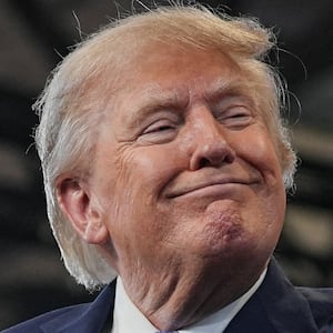 Donald Trump smiles as he delivers remarks at the David S. Mack Center for Training and Intelligence in Garden City, New York.