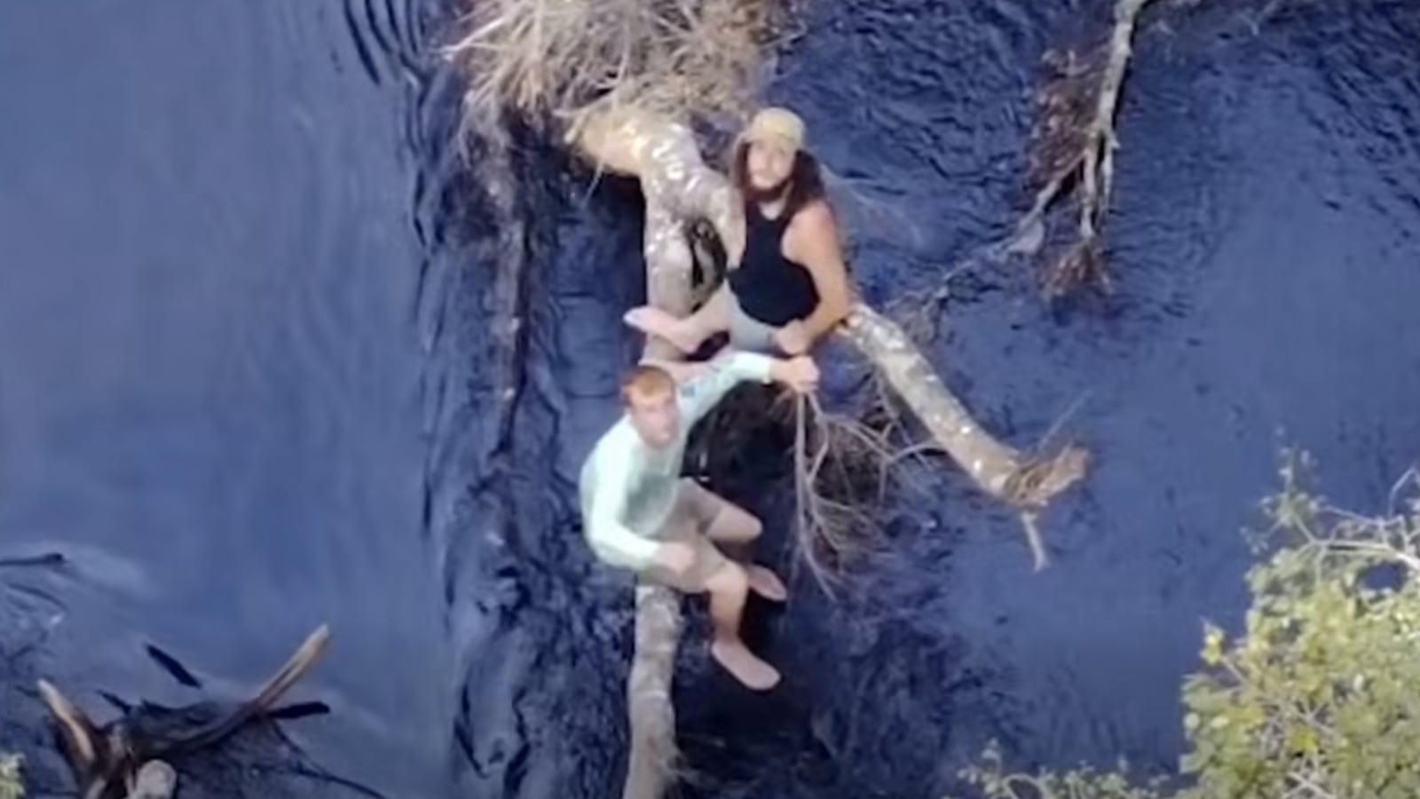 Two boaters stranded on a Florida river wait to be rescued.