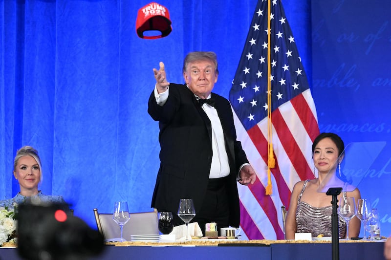 Donald Trump throws his "Trump 2028" hat into an unappreciative audience at this year's 2026 White House Correspondents' Association Dinner.