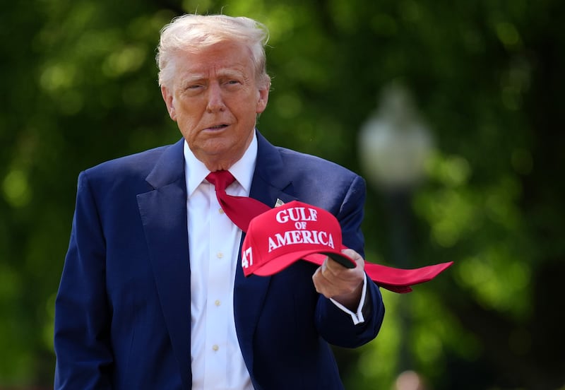 WASHINGTON, DC - APRIL 29: U.S. President Donald Trump holds a hat as he walks to speak to members of the media before boarding Marine One on the South Lawn of the White House on April 29, 2025 in Washington, DC. Trump will travel to Michigan for a 100th Day in Office rally. (Photo by Andrew Harnik/Getty Images)