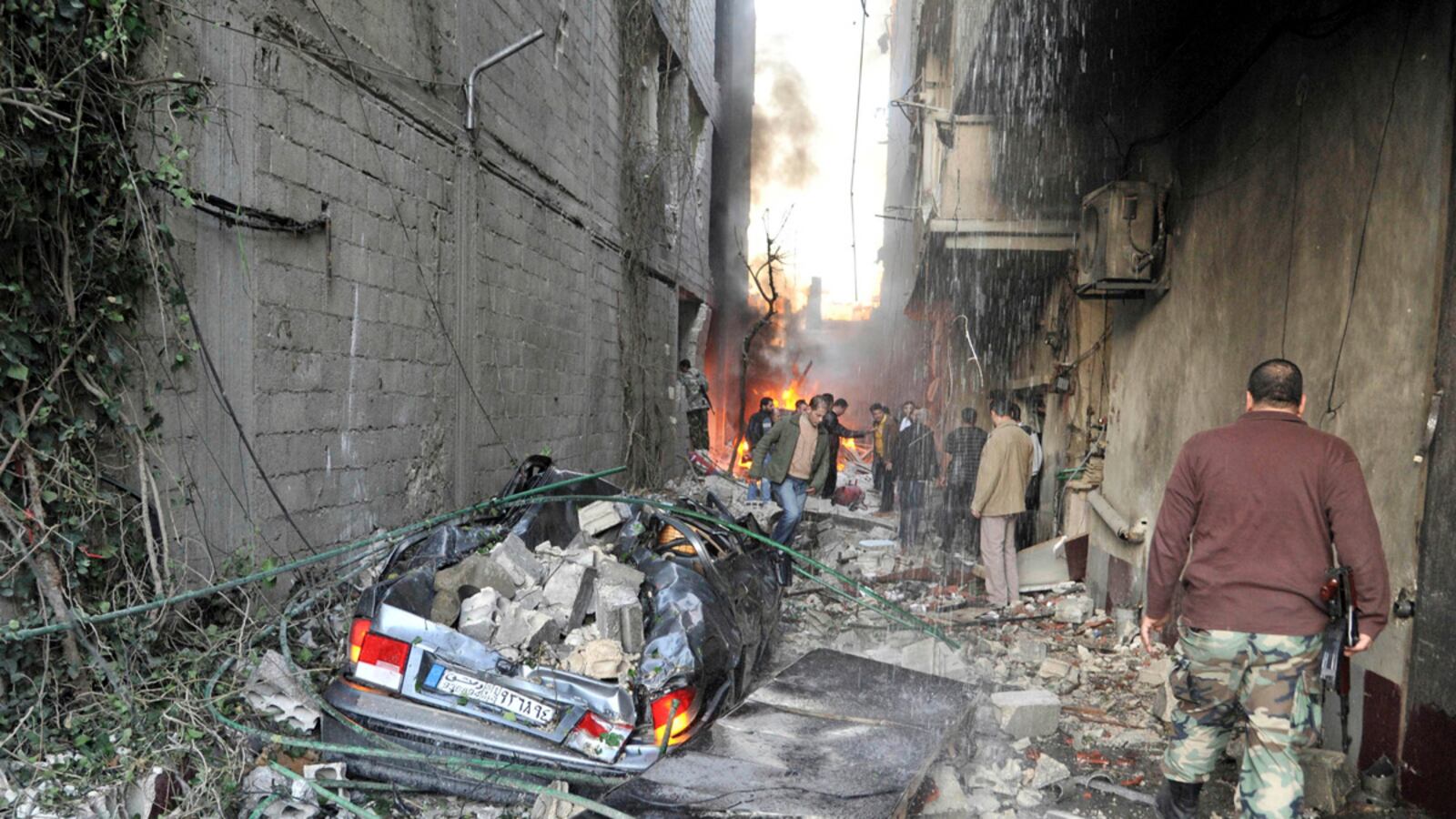 articles/2012/11/28/a-damascus-whodunit-syrian-bombings-kill-dozens/giglio-car-bombing-damascus-tease-embed_j8cqbb