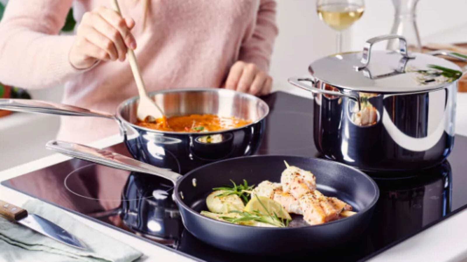 Woman preparing a meal using the Maestro 10-Piece Set by Alva Cookware