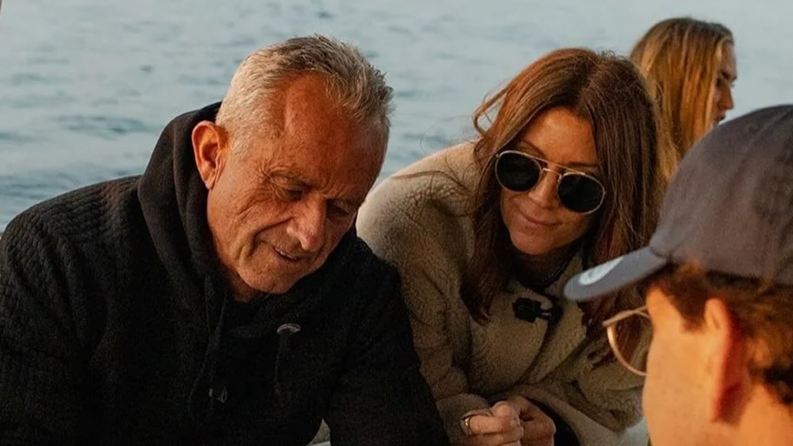 Robert F. Kennedy sits on the deck of a yacht alongside influencer Jessica Reed Kraus.