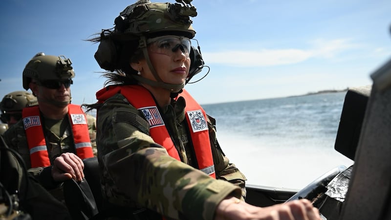 US Secretary of Homeland Security Kristi Noem (R) pilots a US Coast Guard Response Boat-Small (RBS) with the Maritime Security Response Team in San Diego, California, on March 16, 2025.