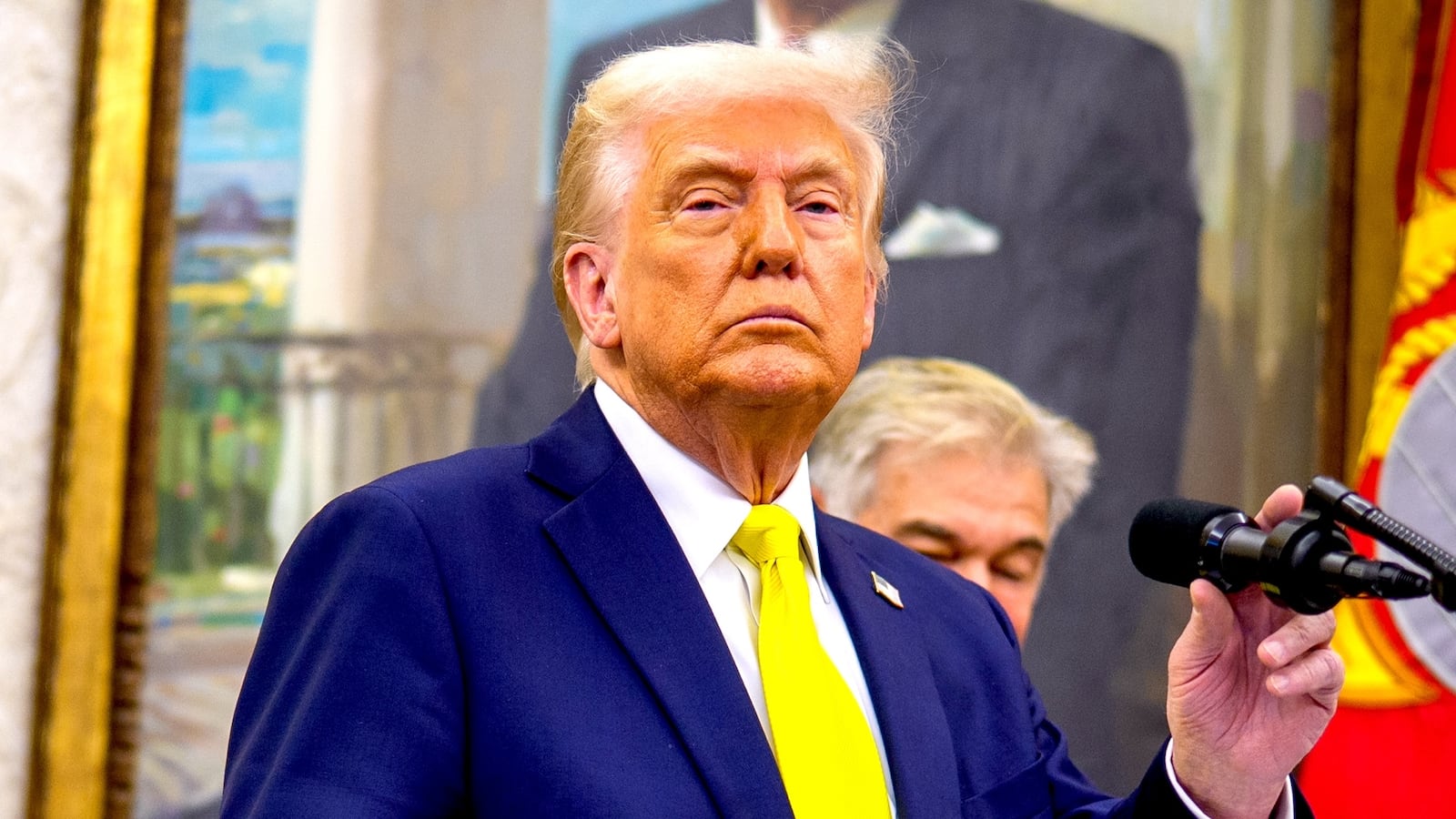 U.S. President Donald Trump, accompanied by Health and Human Services Secretary Robert F. Kennedy Jr. (L), takes a question