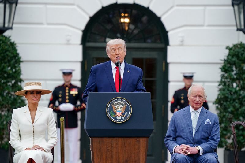 U.S. President Donald Trump speaks next to first lady Melania Trump and Britain's King Charles during an arrival ceremony for King Charles and Queen Camilla on the South Lawn of the White House in Washington, D.C., U.S., April 28, 2026. REUTERS/Nathan Howard