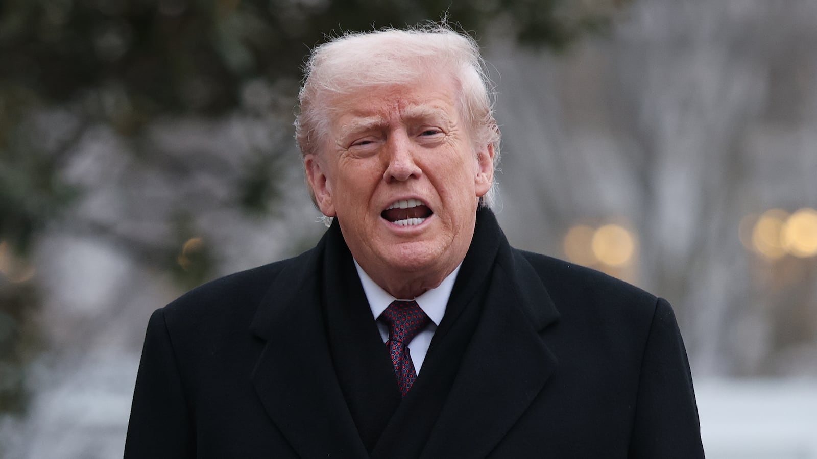 WASHINGTON, DC - DECEMBER 17: U.S. President Donald Trump shouts an answer to a reporter's question as he returns to the White House December 17, 2025 in Washington, DC. Earlier, Trump attended a dignified transfer ceremony at Dover Air Force Base for two members of the Iowa National Guard killed in Syria. (Photo by Win McNamee/Getty Images)