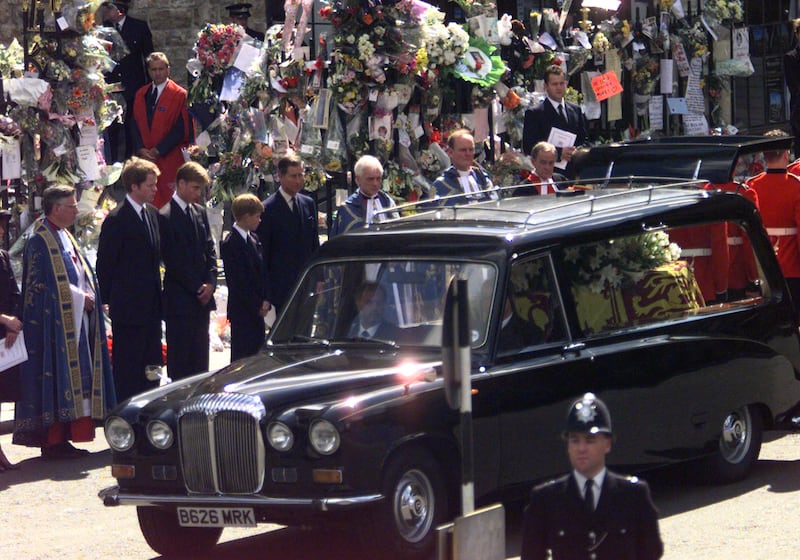 (L-R) Earl Spencer, Prince William, Prince Harry and Prince Charles watch as the coffin containing the body of Diana, Princess of Wales, is driven away from Westminster Abbey for her burial, September 6.