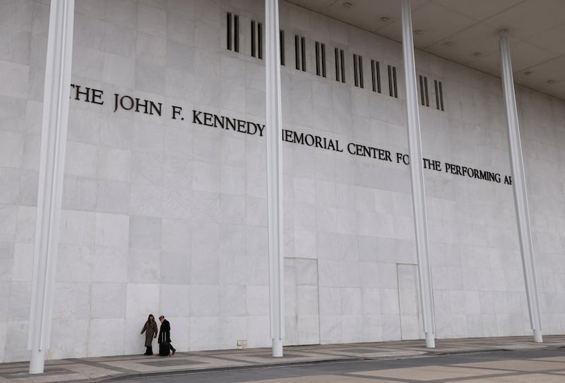 People walk along the front of the John F. Kennedy Center for the Performing Arts, after White House spokeswoman Karoline Leavitt announced that the Kennedy Center board decided to rename the institution the Trump-Kennedy Center in Washington, D.C., U.S., December 18, 2025.