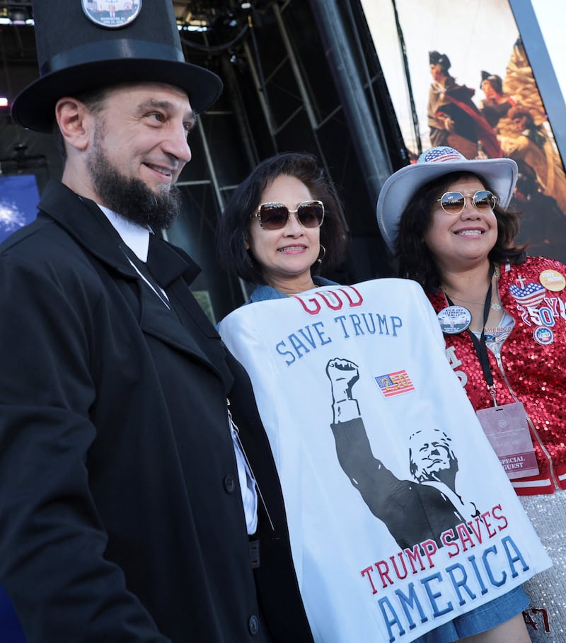 Trump fans pose for a picture ahead of a rally kicking off the Great American State Fair.