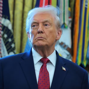 U.S. President Donald Trump listens during a ceremony for the presentation of the Mexican Border Defense Medal in the Oval Office of the White House on December 15, 2025 in Washington, DC.